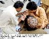Next picture :: Artist decorates hand of a youth with tattoo to earn his  livelihood