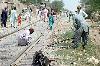 Next picture :: Railway workers repair track after derail of  cargo-train in Dera Allahyar area in Jaffarabad