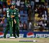 Shahid Afridi is congratulated by Shoaib Malik